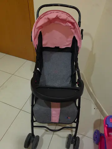 Lightweight pink and grey baby stroller in good condition.