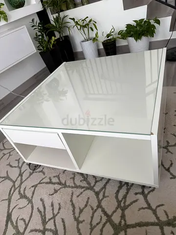 White modern side table with glass top and open cubby storage