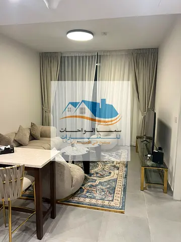The apartment is located in the Al-Jada area and features one bedroom, a living room, a bathroom, and a balcony with an open view. The building includ