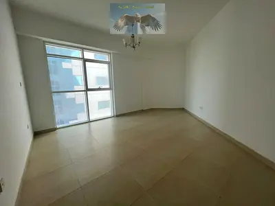Two bedrooms and a living room with a balcony, storage room, laundry room, and parking