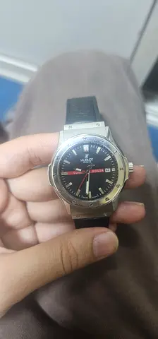 Vintage mechanical mens wristwatch with black dial and leather strap