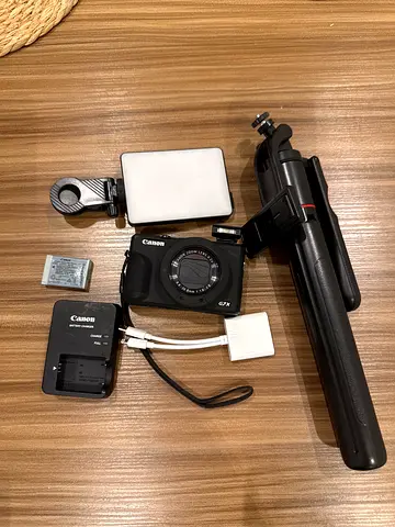 Canon PowerShot compact camera with charger, spare battery, tripod and LED light