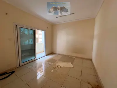 Spacious 1-bedroom apartment in Al Qasmeh Al Mahatta – balcony with open city view – prime location – central AC – near Dubai exit.