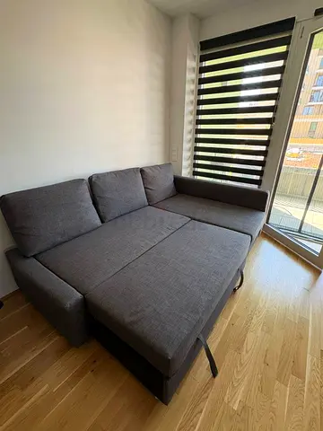 Compact grey fabric sofa bed with storage — good condition