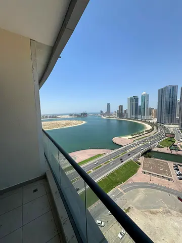 The finest and most luxurious two-bedroom apartment with a maid's room in Al Mamzar, Sharjah, with a lake and sea view, free air conditioning, gym, sw