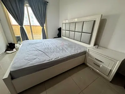 White King Size Bed with Padded Headboard and Matching Nightstand