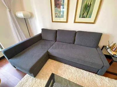 L-shaped grey fabric sofa bed good condition, chaise on left