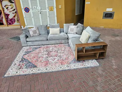 Flexform L-shaped grey fabric sofa with built-in wooden side shelf + patterned rug