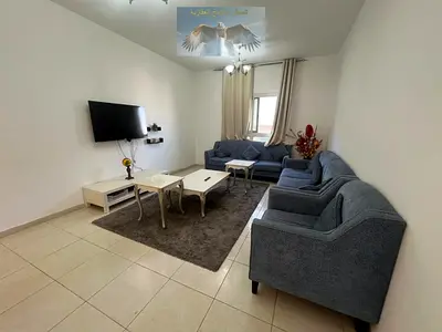 Furnished 1-bedroom apartment with living room and balcony, includes internet, great view, and easy access to Dubai.