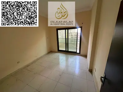 Two bedrooms and a living room in Emirates City. Price 32,000 AED in four installments, including parking in the tower, gym, and swimming pool.