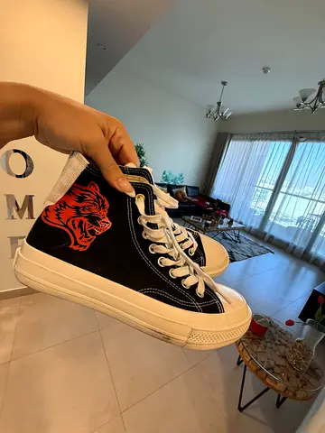 Black high-top canvas sneakers with tiger print, lightly used