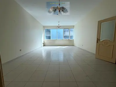 Spacious two-bedroom apartment with a living room in Al Taawun/free air conditioning/close to daily services/close to the Dubai exit