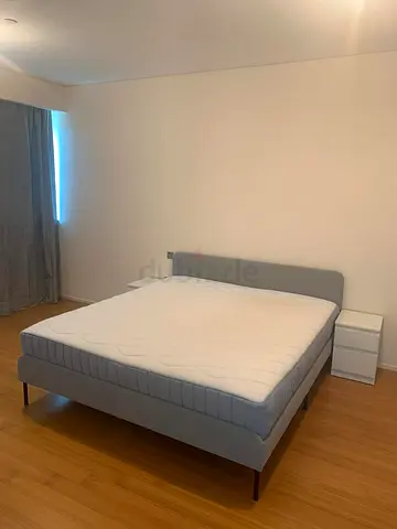 Light grey double bed frame with mattress