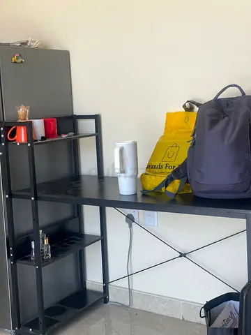 Black metal desk with attached shelving — compact workstation