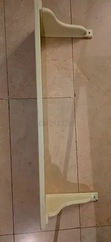 Wooden wall shelf with decorative bracket — used