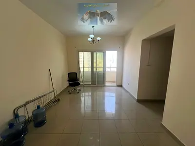 2-bedroom apartment with living room in Abu Shagara, balcony with open view, central AC, spacious practical layout, near markets, transport & services