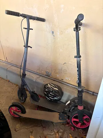 Two foldable kick scooters with helmet - used, good condition