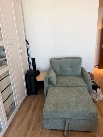 Single green upholstered armchair with ottoman. Bought at Pan Home Price new is 2800 aed