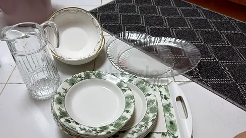 Mixed dinnerware set with serving platter, pitcher and cutting board — good condition