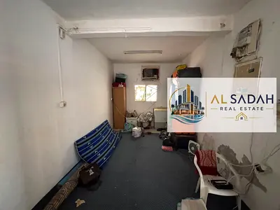 For sale: House in Al-Qadisiyah. The house is divided into two sections: the first section has 3 bedrooms, a living room, and a kitchen; the second section has 2 bedrooms, a living room, and a kitchen