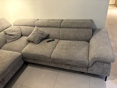 Light grey L-shaped fabric sofa with adjustable headrests (3-seater section)