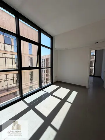 One-bedroom apartment for sale in Sharjah, Al Mamsha area. The apartment consists of a bedroom, living room, and a shared kitchen.