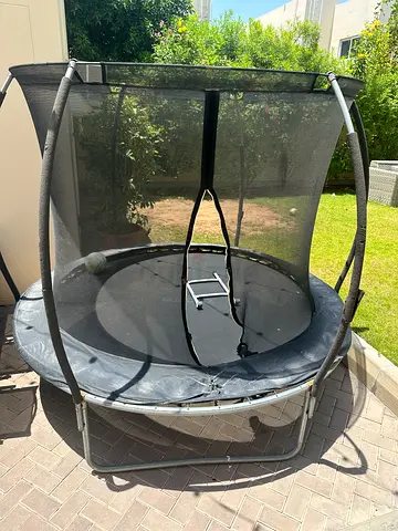 Used round trampoline with safety enclosure - good condition