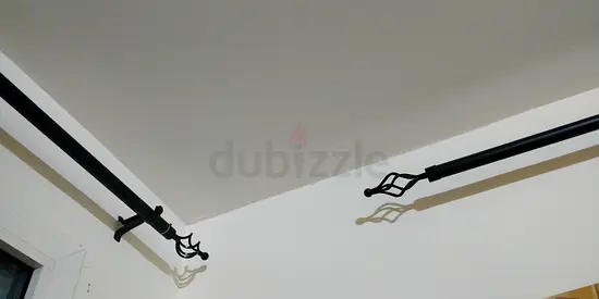 Curtain rods with elegant end finials and curtain rod holder