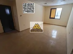 A spacious studio for annual rent in Al Alia – Ajman, featuring a semi-separate kitchen and centra