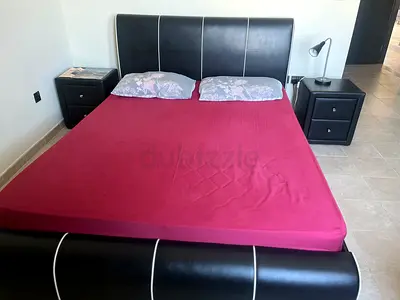 Black faux leather double bed with matching bedside tables