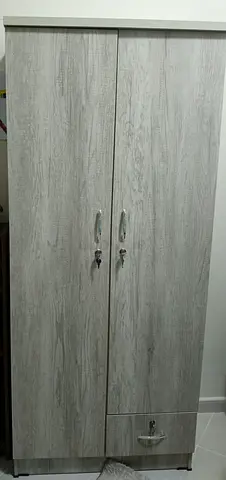 Two-door freestanding wardrobe with drawer — light wood finish