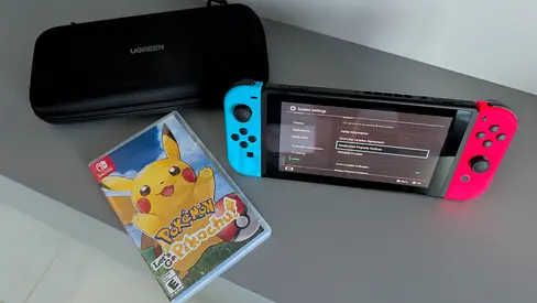 Nintendo Switch with Joy-Cons (Neon) + Pokémon: Let’s Go Pikachu and Carry Case