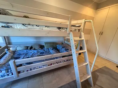 Solid wood white/cream bunk bed with wood grain design in greyish hues with ladder from ID Design