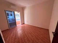 For annual rent in Rawda 2, Ajman - one bedroom and living room - balcony - split AC - suitable for
