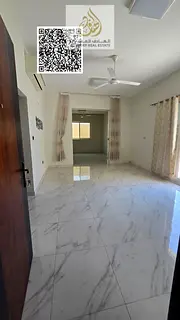 Two-bedroom apartment with a living room and majlis (formal sitting room) for annual rent, with a pr