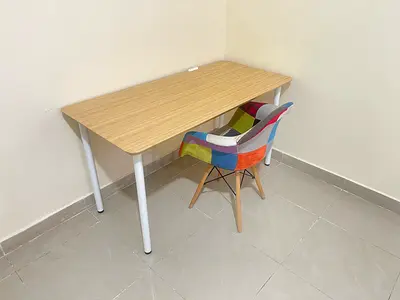 Simple wood-top study desk with colorful patchwork chair