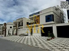 In Al-Aliya, on a 4350 sq ft plot, this two-story villa with a rooftop terrace features 7 master bed