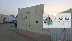 Corner house for sale in Umm Khanoor, with 3 bedrooms, living room, kitchen, and majlis. Area: 2500