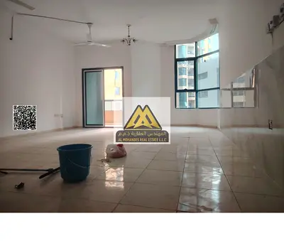 2BR + maid in Al Khor Towers, Ajman. 3 baths, 2 balconies, open view. AED 40,000 yearly, 4 payments. Prime location in Al Rashidiya.