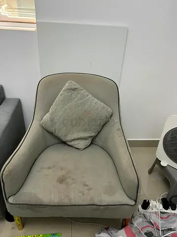 Single grey upholstered armchair with cushion — used, some stains 2 chair for 100 aed
