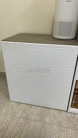 Small textured white bedside cabinet with wood top