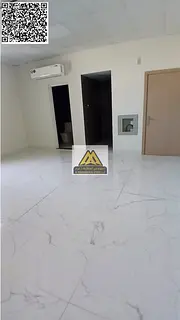 A spacious studio for annual rent in Al Jurf 2 – Ajman, featuring a separate kitchen and split AC,