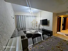 Luxuriously furnished two-bedroom apartment with a living room and private parking.