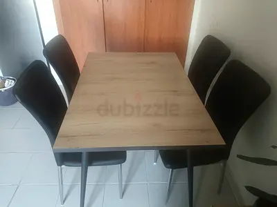 Wooden dining table with 4 black chairs - good condition