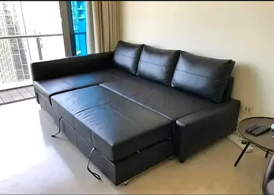 Black L-shaped Leather Sofa Bed with Storage - Good Condition