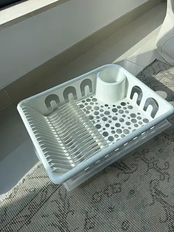 White plastic dish drying rack with cutlery holder