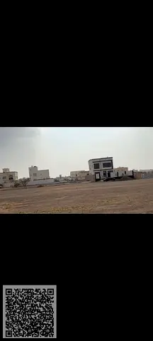 4 plots of land in Manama 13 for sale directly on the asphalt, very prime location