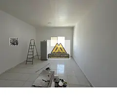 Studio in Al Rashidiya 3, Ajman, large space, semi-open kitchen, central AC, wardrobes, parking, AED