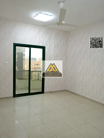 2BR apt Al Rashidiya Towers Ajman. Spacious, balcony, 2 baths. AED 40,000 yearly, 4 payments. Prime location, full services nearby.