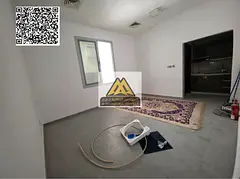 A spacious ground-floor studio for annual rent in Al Rawda 1 – Ajman, featuring a semi-separated k